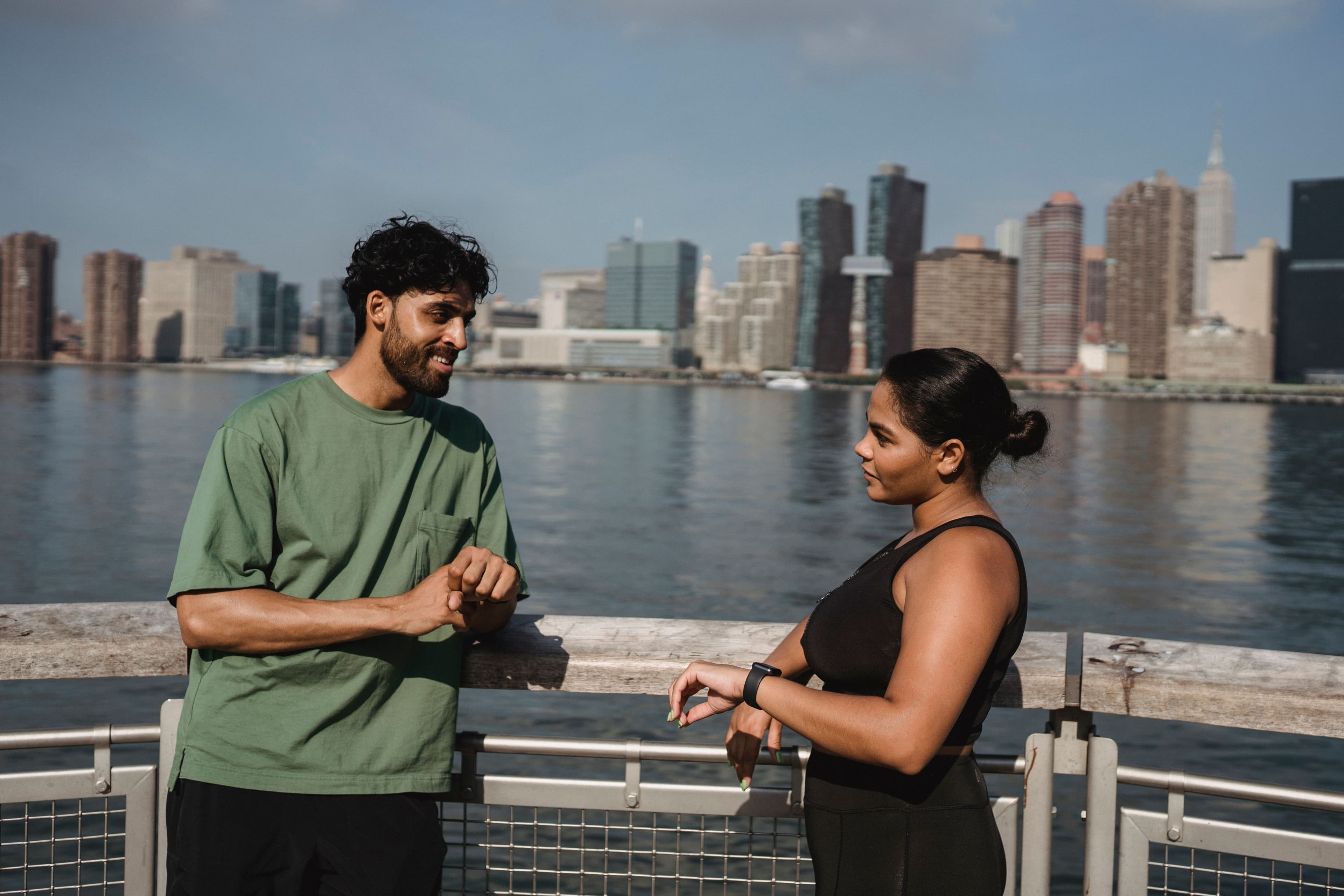 Runners pausing at a viewpoint overlooking the city skyline